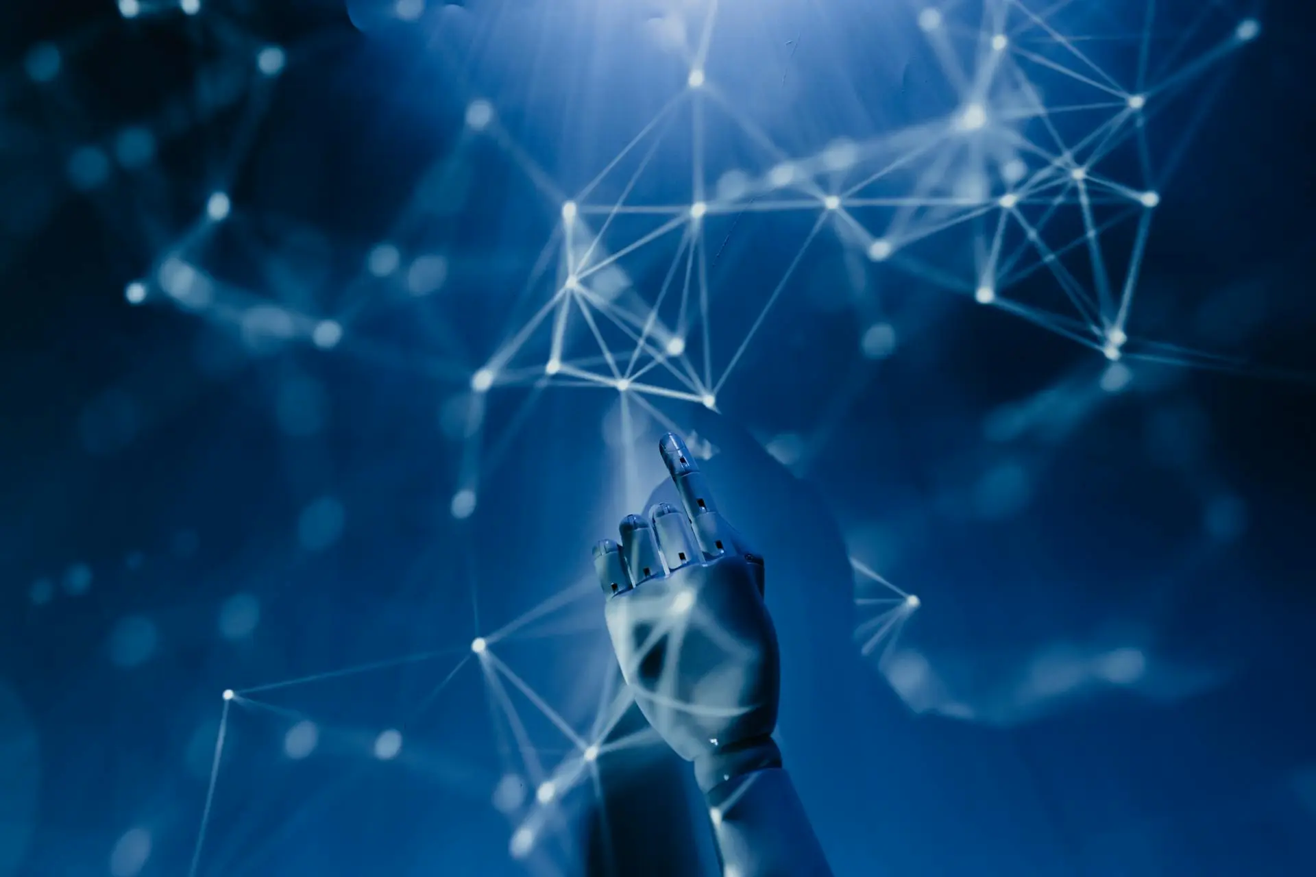 A robotic hand pointing towards a glowing abstract digital network, symbolizing artificial intelligence and advanced technology in web development and online connectivity. This image represents the innovative digital solutions provided by Launchpad Web Designs