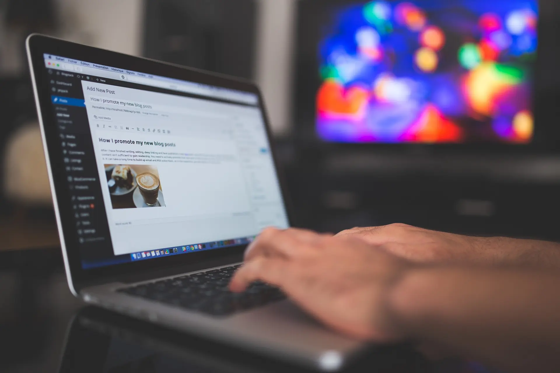 Person typing on a laptop, working on a blog post with an image of coffee, representing Launchpad Web Designs' Website Copywriting Kit for Small Businesses to create compelling website content.